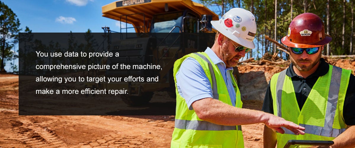 Two technicians standing on a job site diagnosing the equipment issue