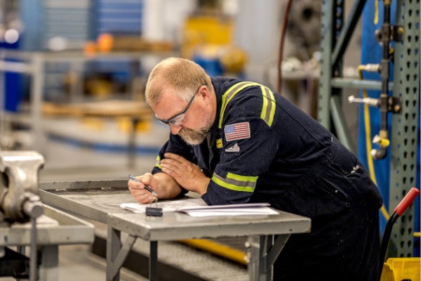 Peterson Technician Planning on Work Bench