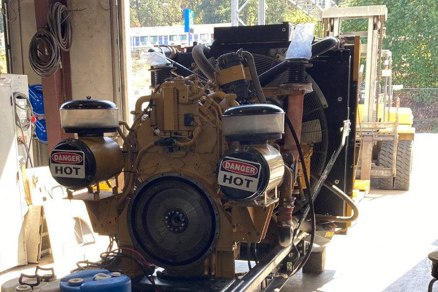A large Cat engine and radiator with the genset removed for major service in the Eugene Power Systems shop