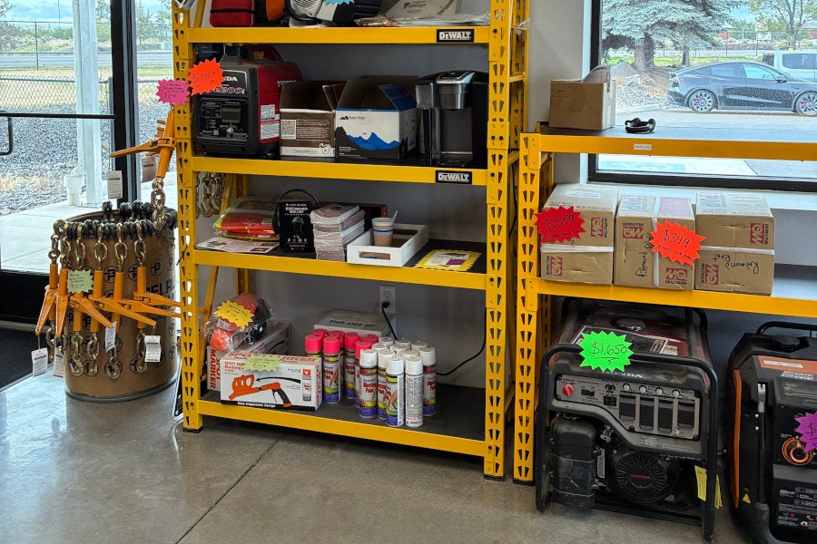 A retail display of contractor tools, small generators, portable welders, and trash pumps