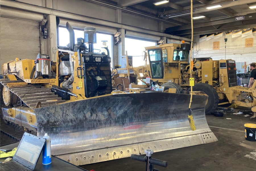 A torn down Cat LGP dozer and a Cat 143H getting major service in the Eugene shop with overhead cranes