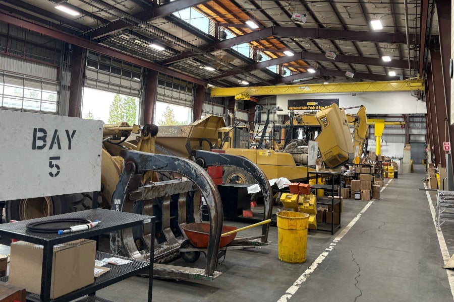 Log loader, articulated truck, and hydraulic excavator in the Santa Rosa service shop