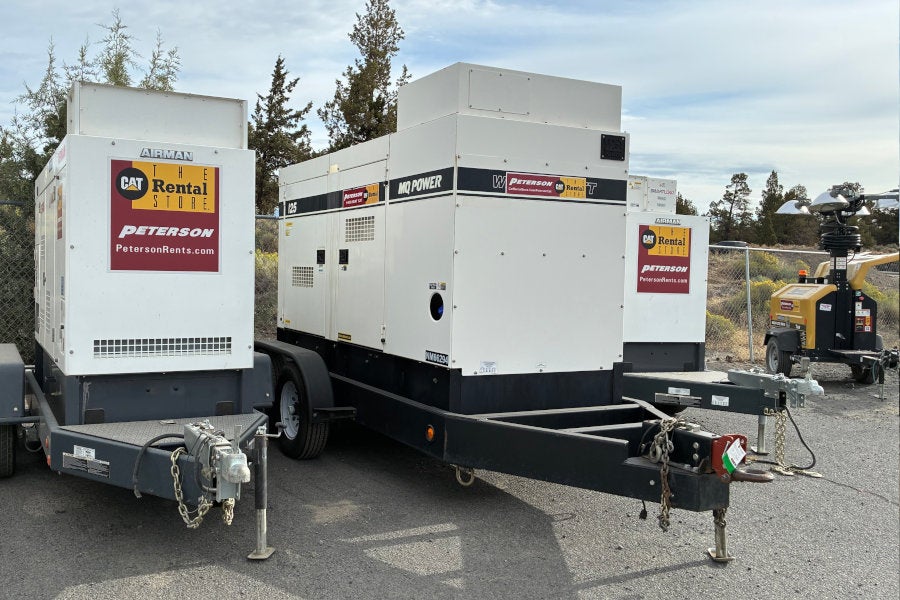 A rental light tower, two towable rental diesel generators, and a towable rental diesel air compressor