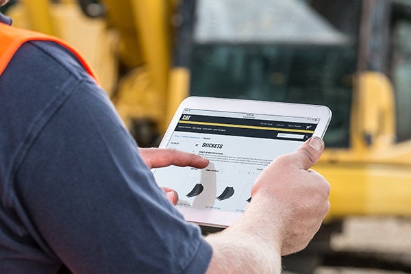 man looking at buckets on an ipad