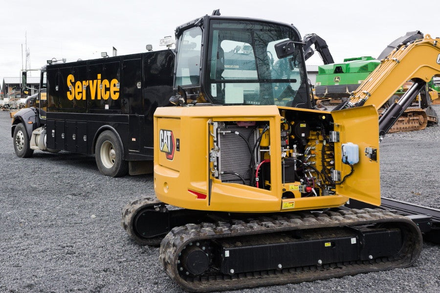 service truck maintaining a mini excavator