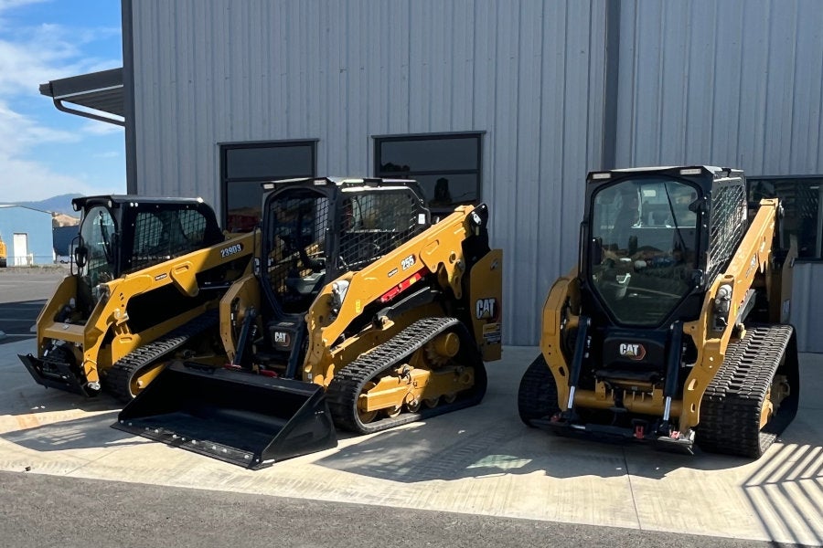 Two compact track loaders with cabs, one compact track loader with open canopy