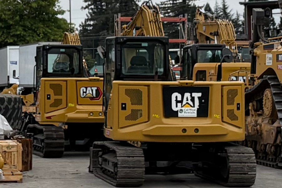 one new and two used mini excavators next to a dozer