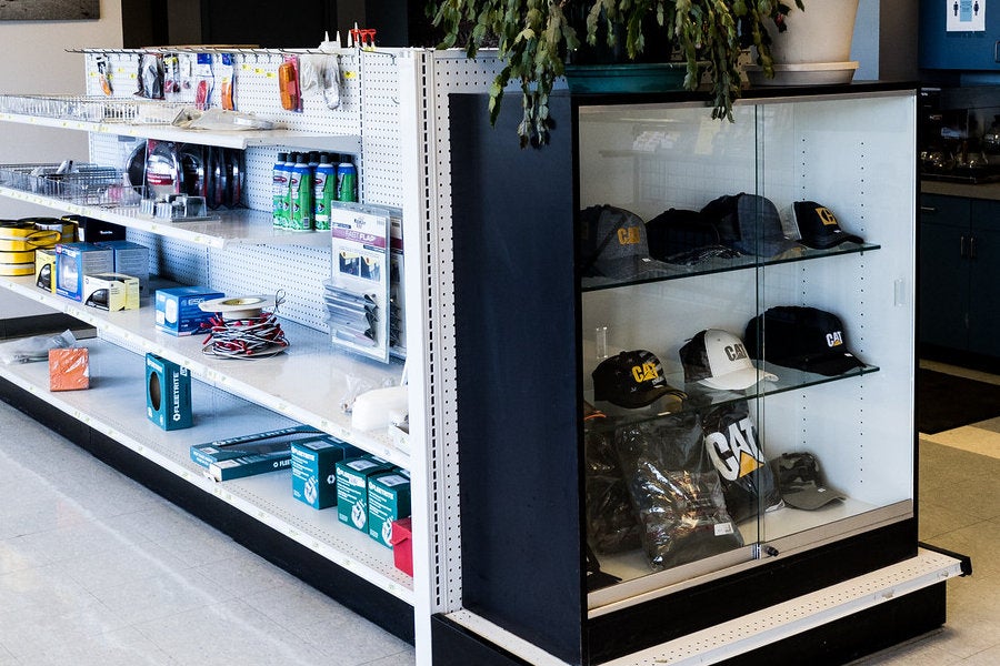 Cat hats and merchandise alongside contractor consumables in a grab-and-go display