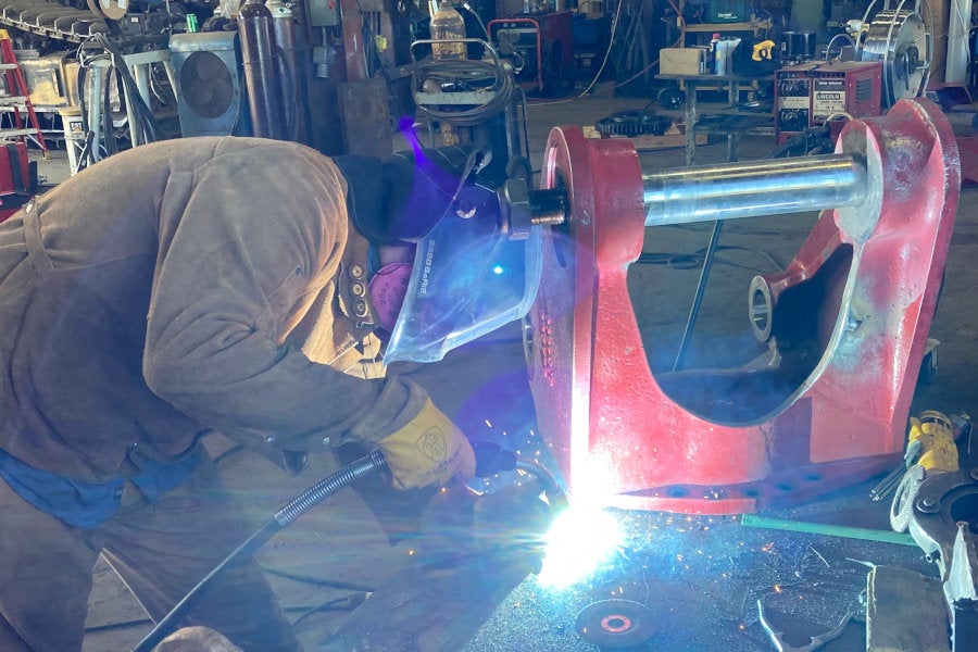 A Peterson certified welder fabricating a work tool in the Eugene shop