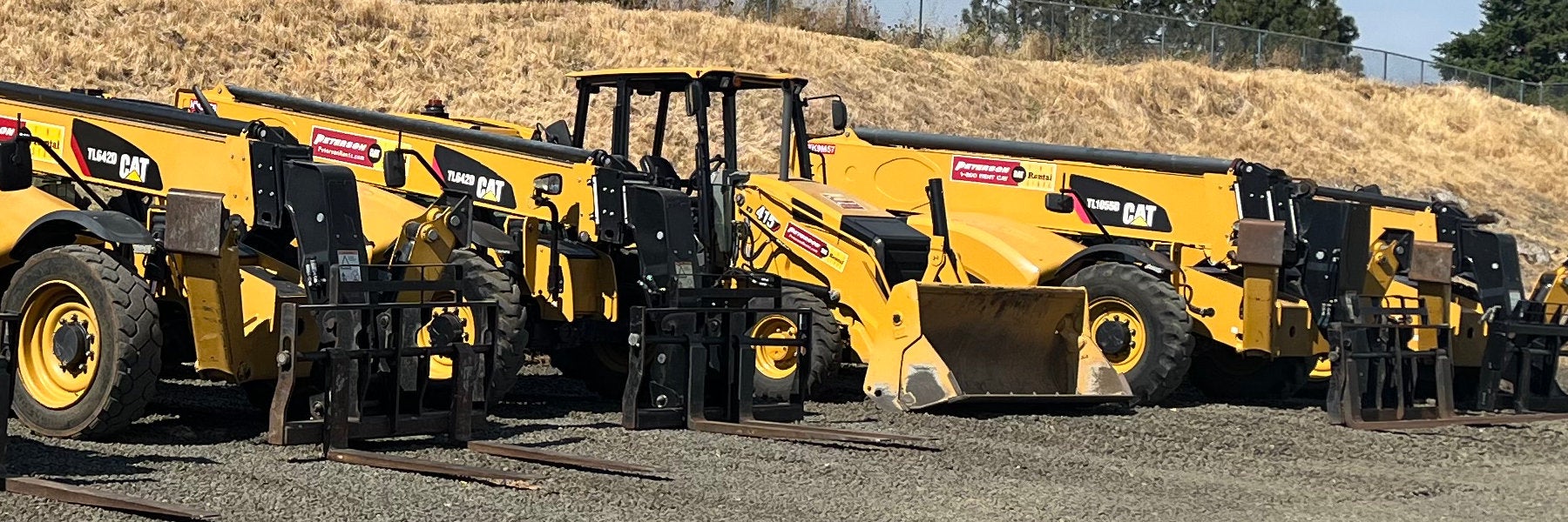 rental-ready line full of telehandlers and an industrial loader.
