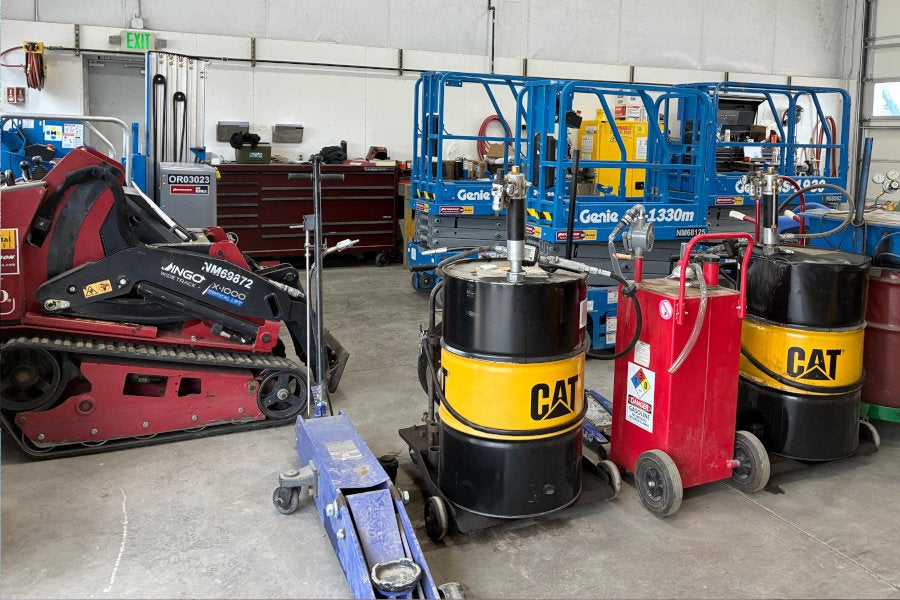 A toro stand-on loader and multiple Genie scissor lifts in the Redmond rental maintenance shop