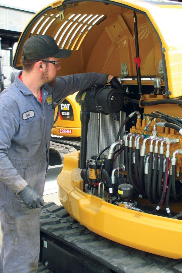 Peterson technician servicing a mini excavator