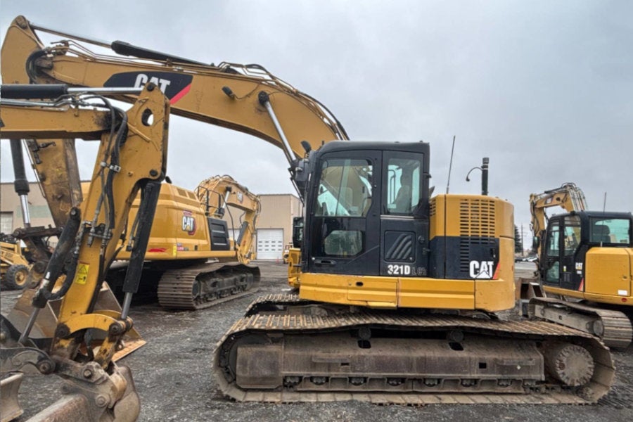 Used excavators in the Redmond equipment yard with a Cat 321 D LCR in the center