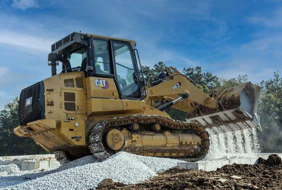 Use your Cat track loader to spread gravel around a foundation