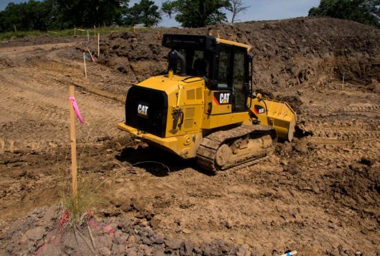 Cat 953K Track Loader working on a home building site