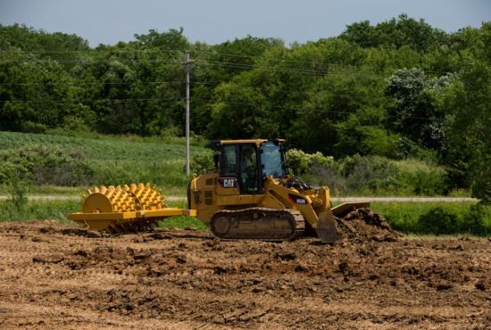 A 953K Track Loader has the versatility to push dirt and tow implements