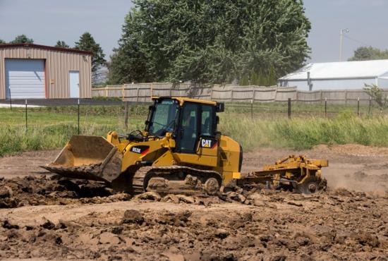 Cat 953K Track Loader pulling a disc