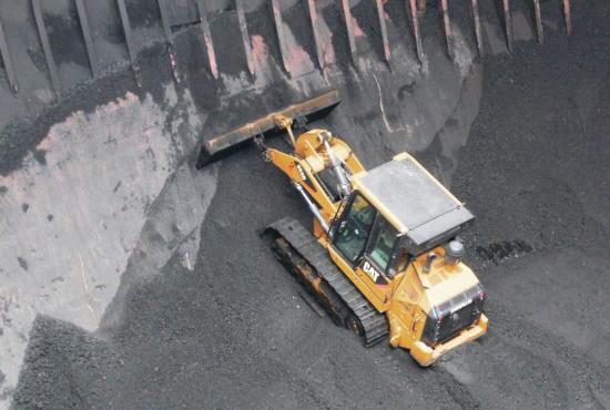 963K Track Loader working in a ship hold