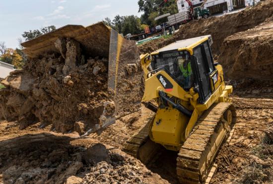 963K Track Loader digging a residential basement