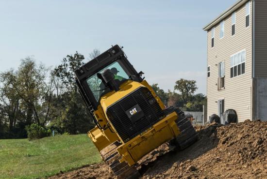 963K Track Loader doing finishing work around a foundation