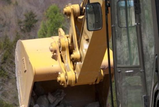 313F Hydraulic Excavator emptying bucket full of rock