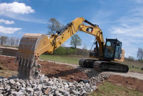 318F L Hydraulic Excavator emptying bucket full of rock