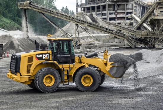 966M Medium Wheel Loader Hauling Rock