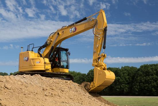 325 Hydraulic Excavator digging on side of a dirt mound
