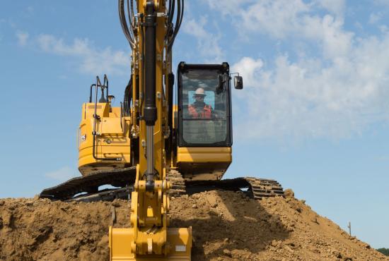 325 Hydraulic Excavator scooping dirt