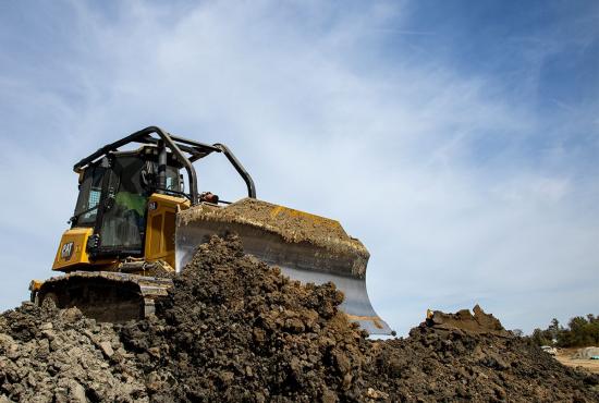 D4 bulldozer filling a trench after underground utility installation