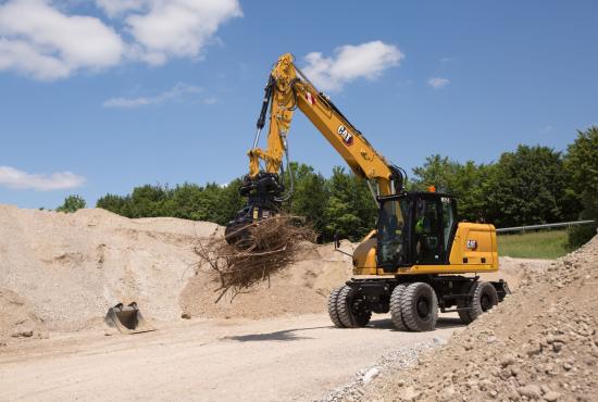 M314 Wheel Excavator moving debris with grapple