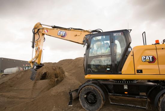 Quickly load trucks with the M318 Wheel Excavator