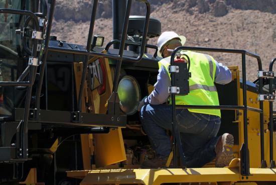 Inspecting 16 Motor Grader engine and filters