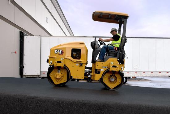CB2.9 tandem vibratory roller compacting asphalt in a parking lot.