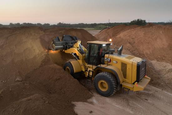 Cat 966 GC Wheel Loader Scooping Dirt with Lights on