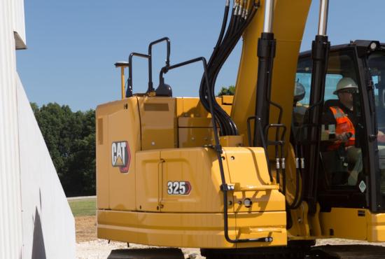 325 Hydraulic Excavator working close to a building structure