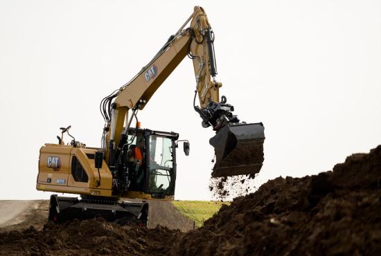 M315 Wheel Excavator digging on the side of the road