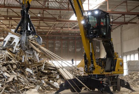 MH3024 moving a pile of wood pieces