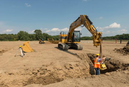 320 GC Excavator helping compact a trench