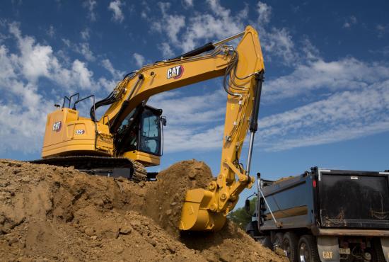 325 Track Excavator loading dirt into a dump truck