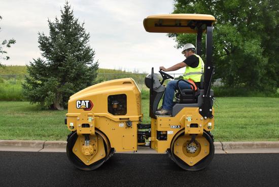 CB2.5 tandem vibratory roller compacting asphalt in a parking lot.