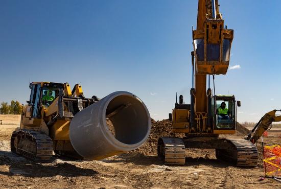 The 973 track loader handles the heavy lifting before installing sewer pipe