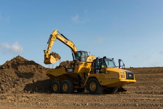 323 Hydraulic Excavator Loading dirt into an articulated rock truck