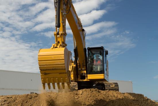 325 Hydraulic Excavator creating a dirt pad