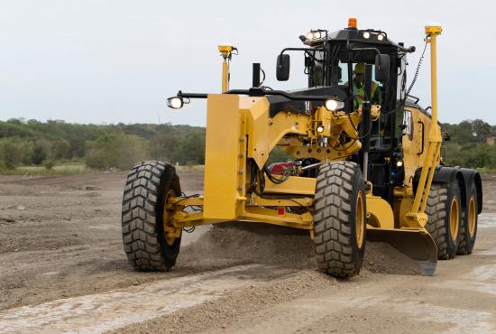 14 Motor Grader pushing earth with moldboard