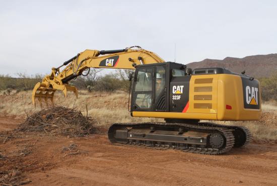 Excavator Rake and Pro Series Thumb working together for site clean-up.
