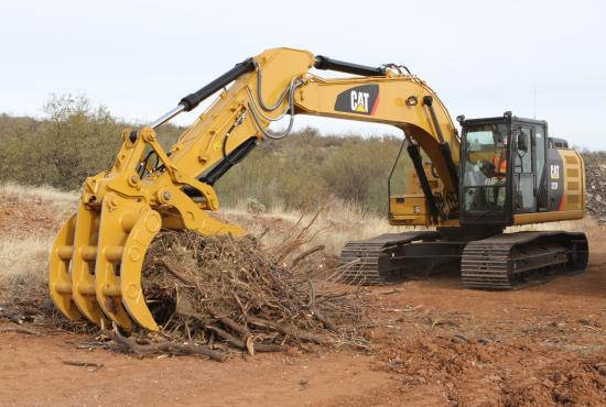 Excavator Rake and Pro Series Thumb working together to handle brush.